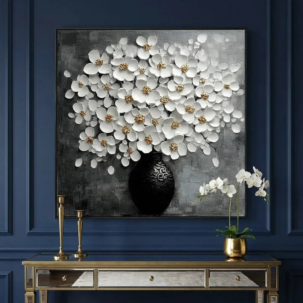 Decorative wall art with white flowers on a dark background, displayed above a console table with decorative items.