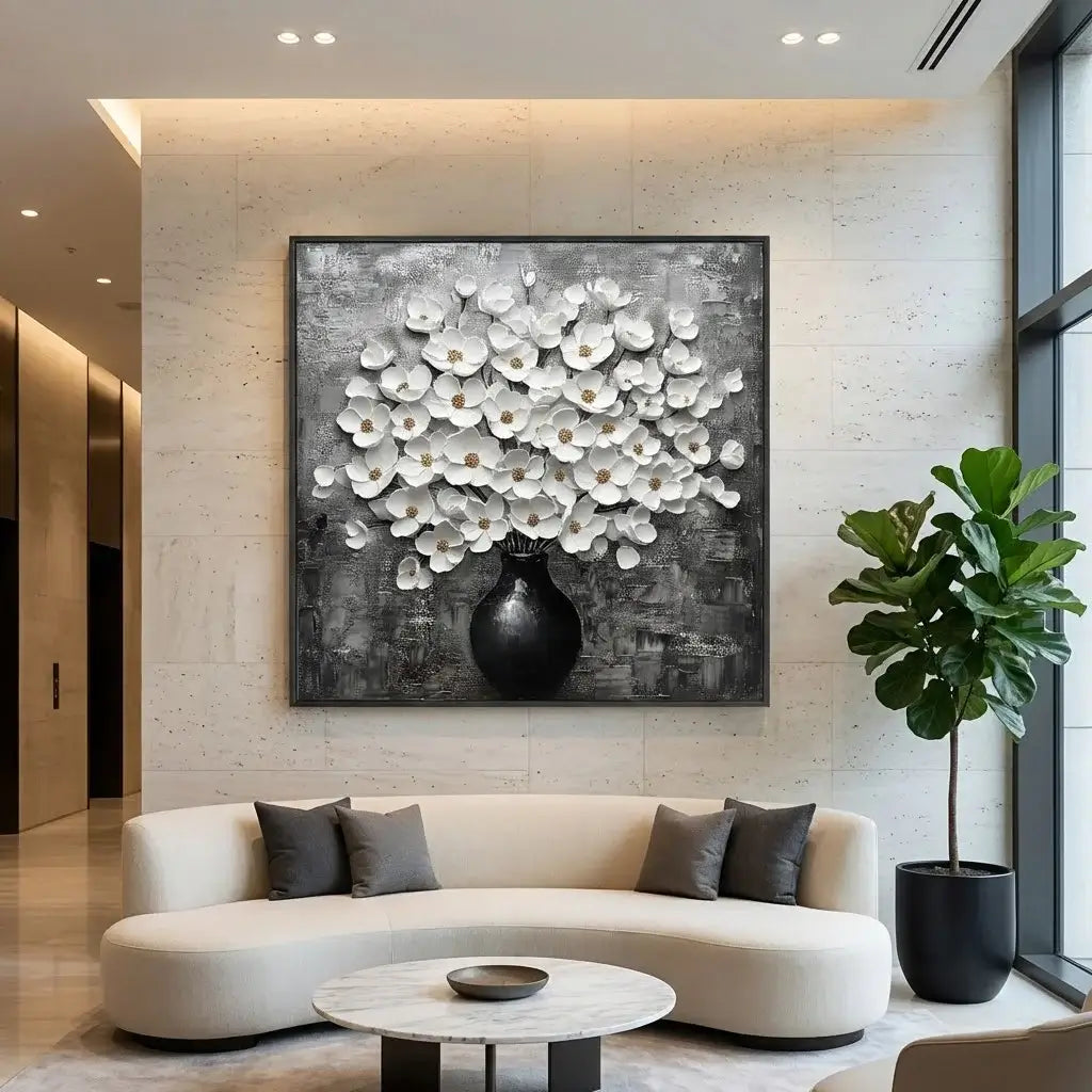 Modern living room with a large floral painting, white sofa, and decorative plant.