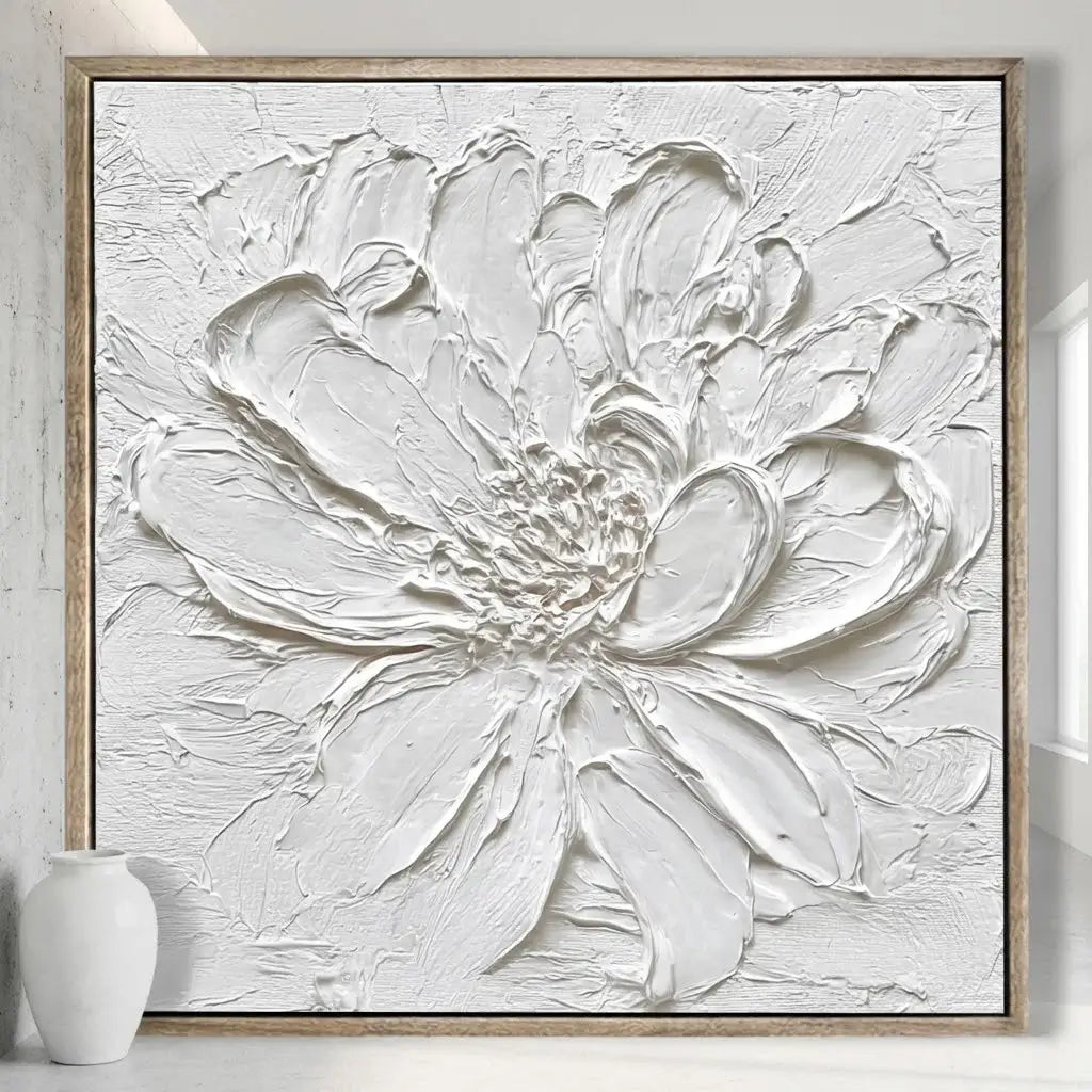 Abstract white flower painting on a wall with a vase in the foreground.