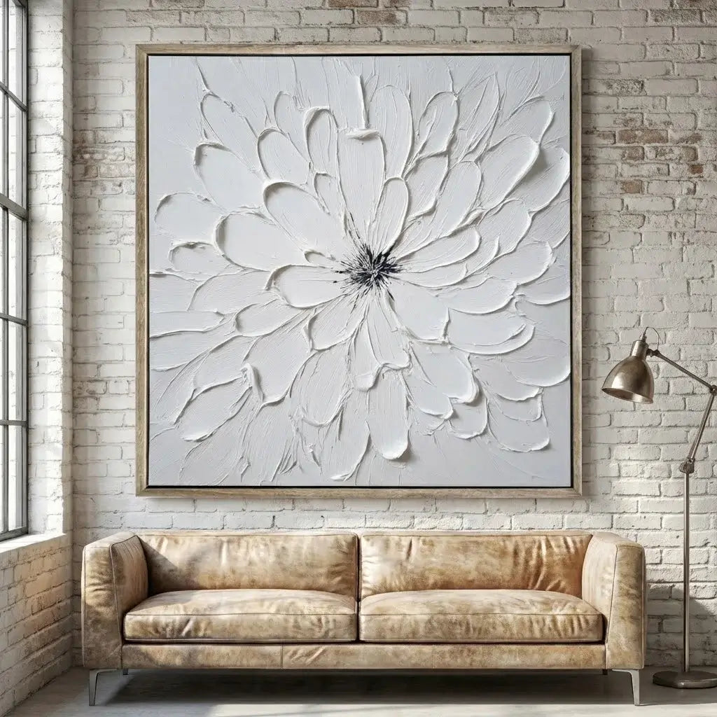 Large floral artwork on a brick wall above a beige sofa.