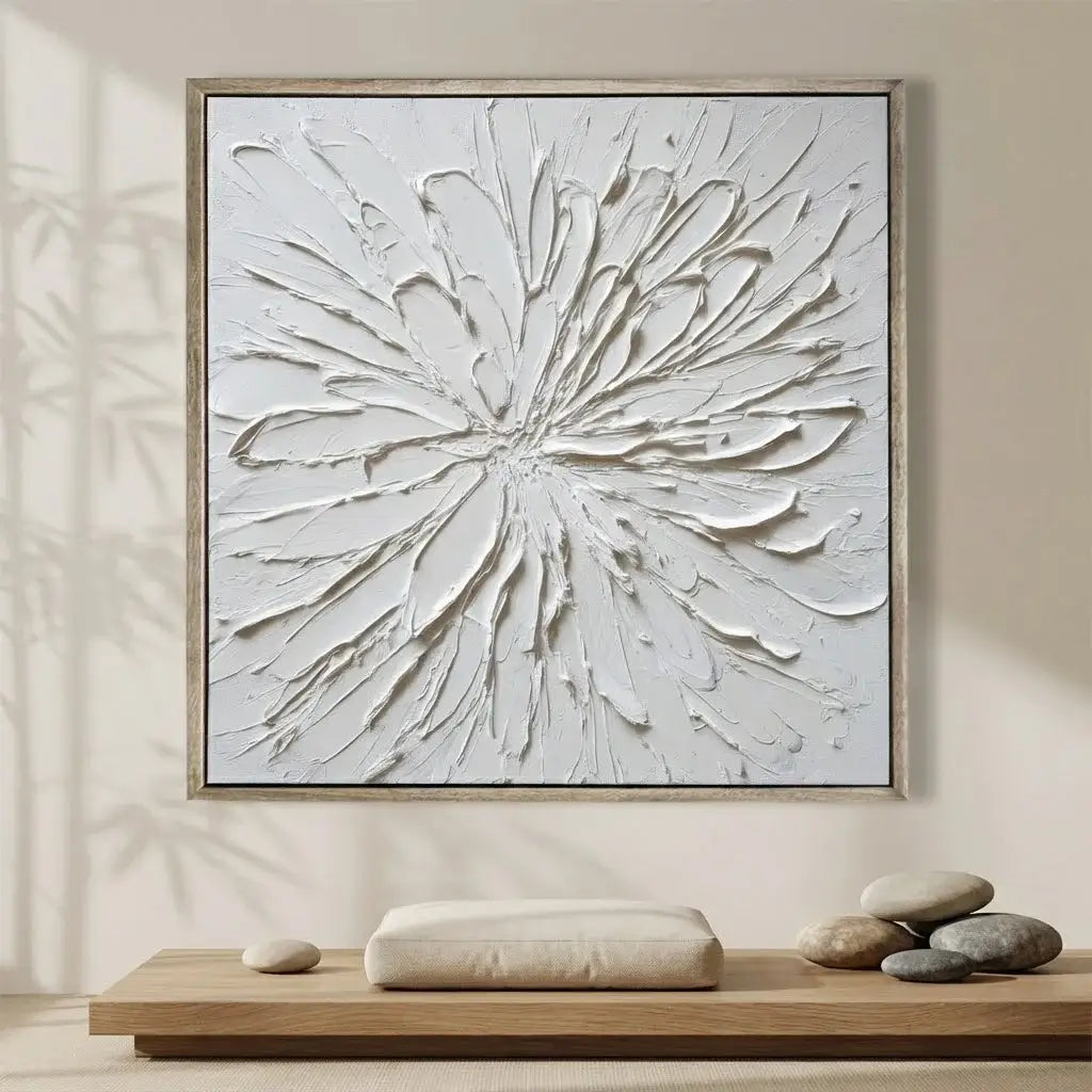 Abstract wall art in a neutral setting with a wooden shelf and stones.