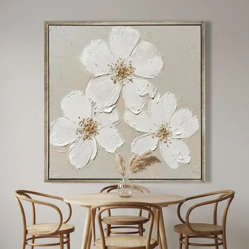 Framed floral artwork above a wooden dining table with chairs.