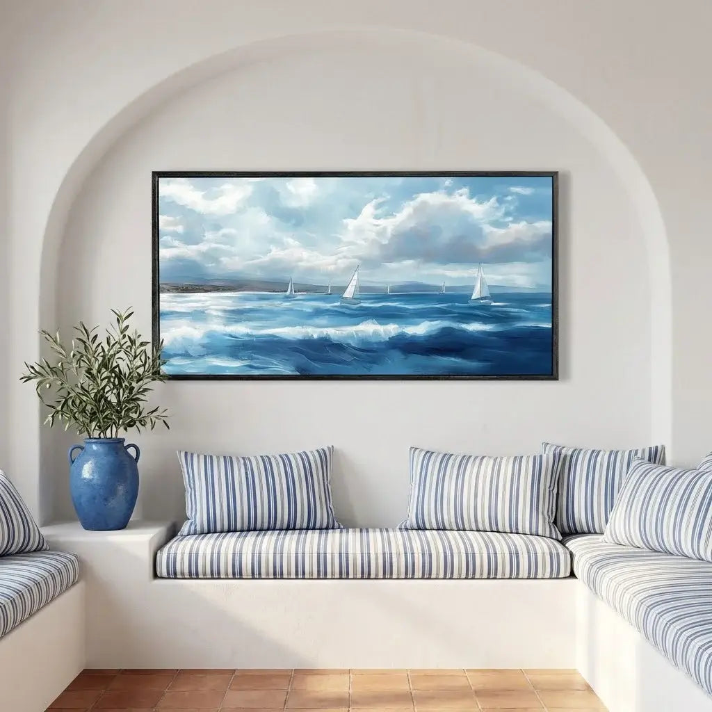 Living room with a large framed seascape painting above a sofa with striped cushions.