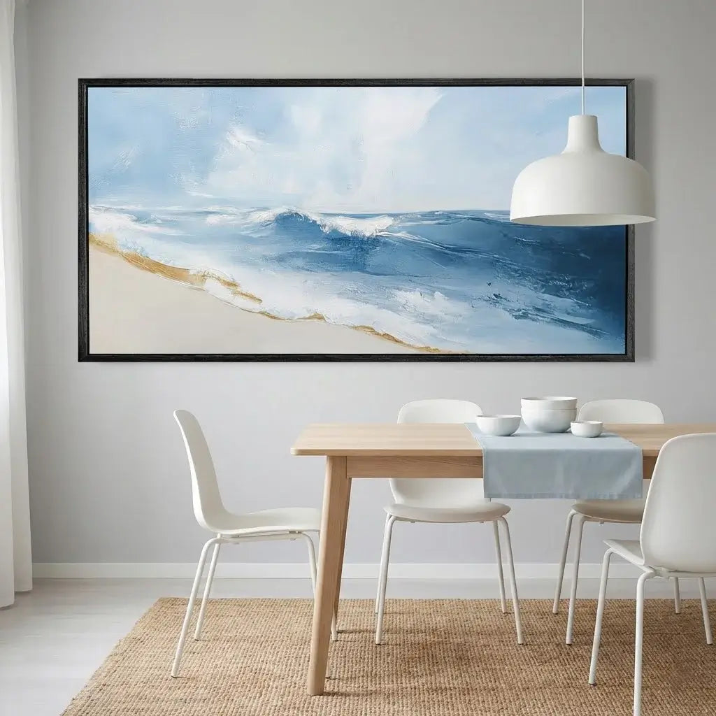 Dining room with a large framed beach scene on the wall above a table.