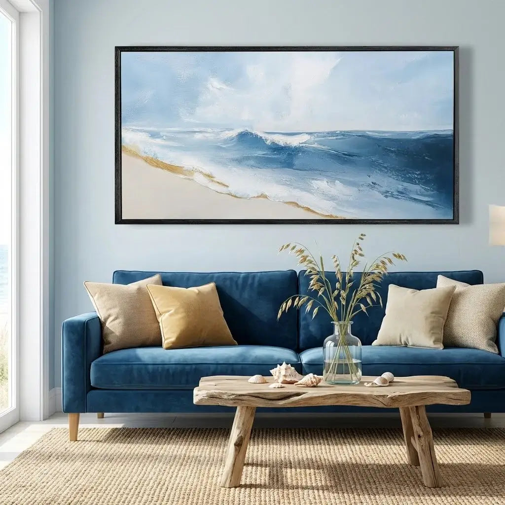 Living room with a blue sofa, wooden coffee table, and beach-themed artwork on the wall.