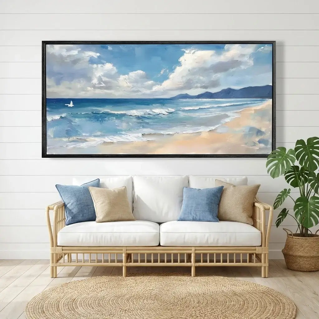 Beach scene painting above a sofa with decorative pillows in a living room setting.