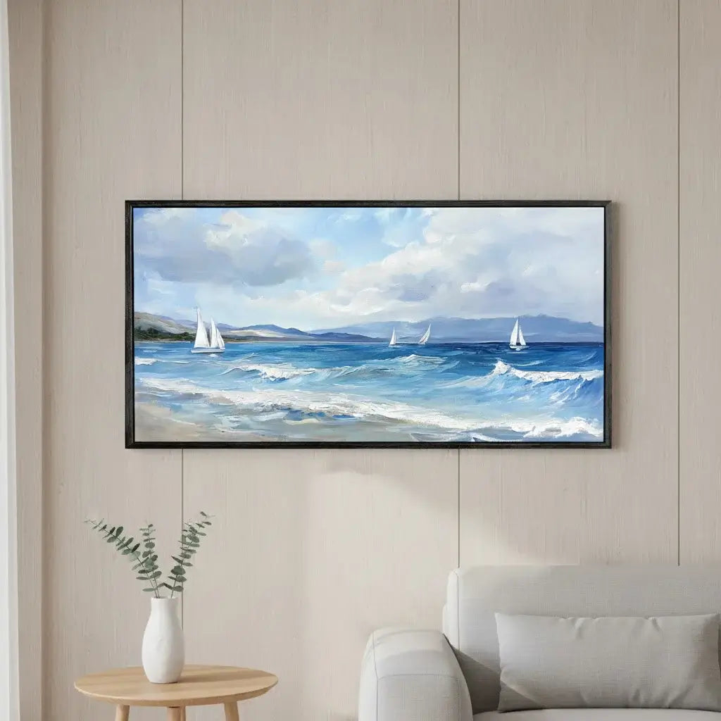 Framed painting of a seascape with sailboats on a wall in a living room.