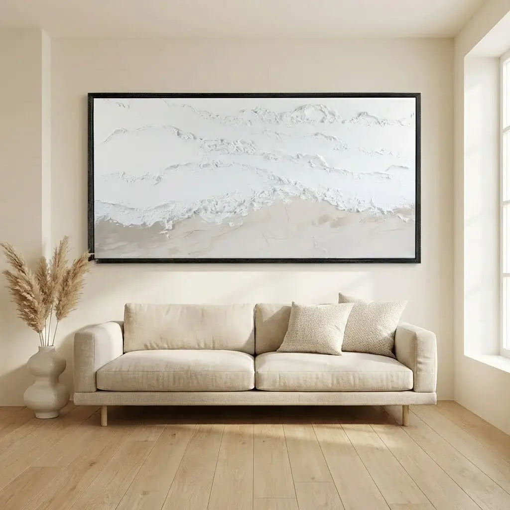 Beige sofa in a room with a large abstract painting on the wall.