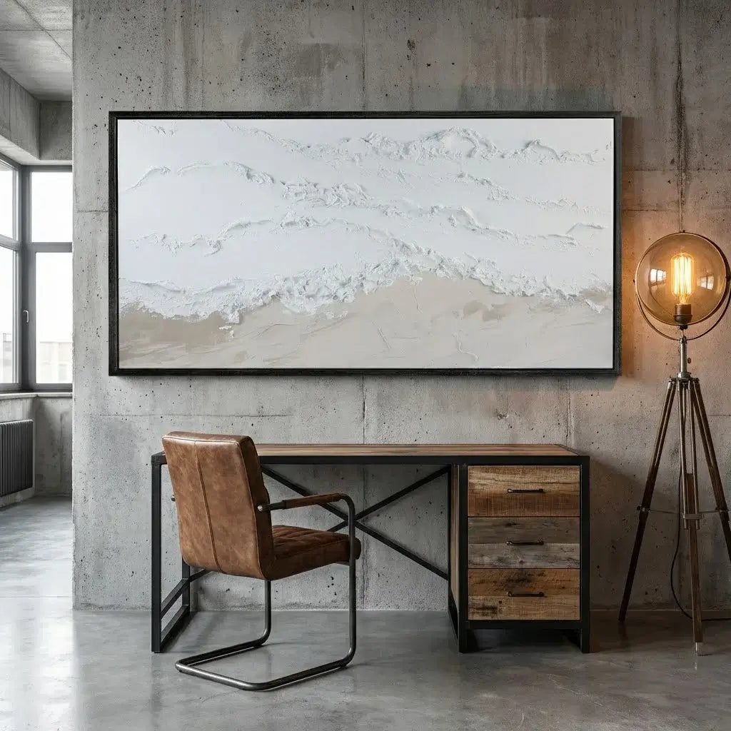 Modern office setup with wooden desk, leather chair, and abstract painting on concrete wall.