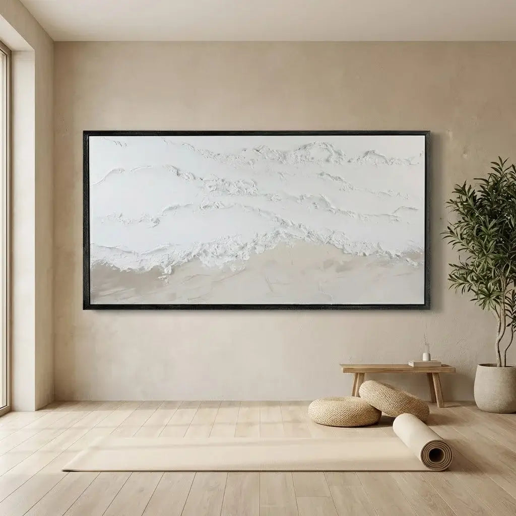 Beige room with a large abstract painting on the wall, a small table, and decorative items.