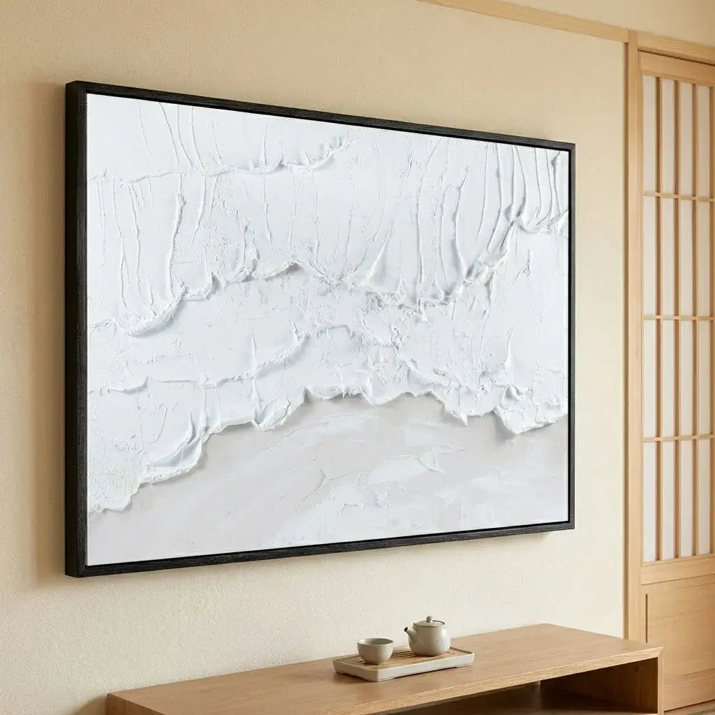 Abstract white artwork on a wall in a room with wooden furniture.