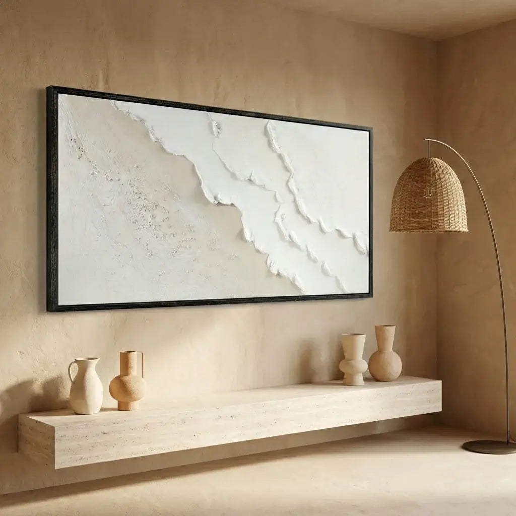 Beige wall with a framed abstract painting, a shelf with vases, and a floor lamp.