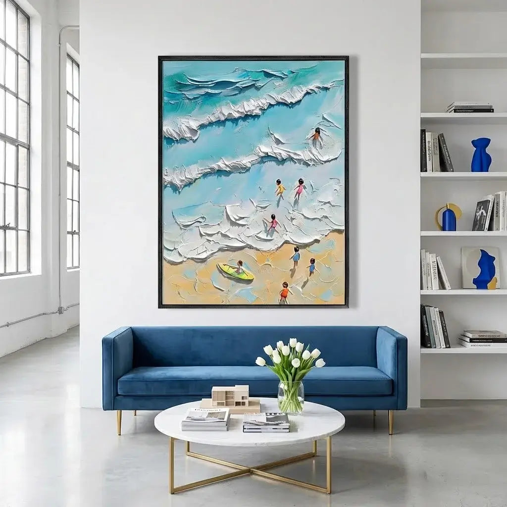 Living room with a blue sofa, white coffee table, and a large beach scene painting on the wall.
