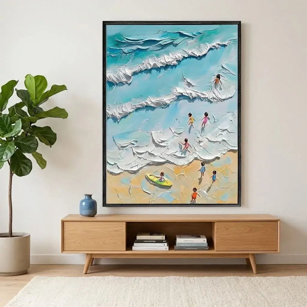 Framed artwork of people on a beach with a wooden cabinet below