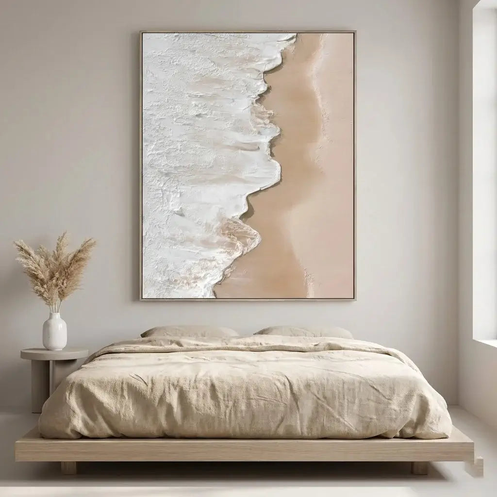 Beige abstract art piece on a wall above a bed in a bedroom.