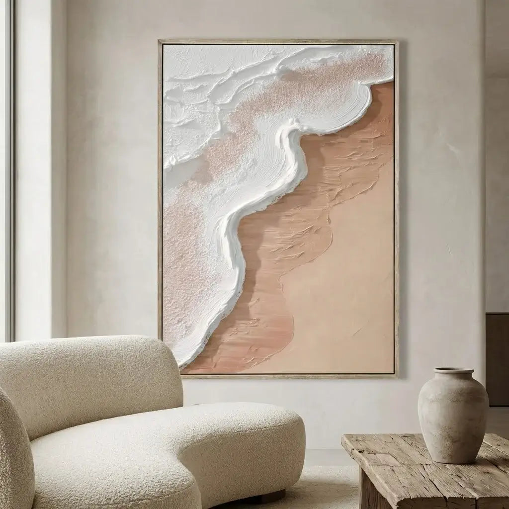 Abstract art piece on a wall in a modern living room with a textured armchair and wooden table.