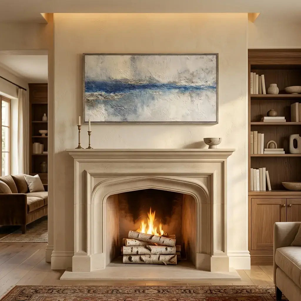 Living room with a fireplace, books, and a painting on the wall.