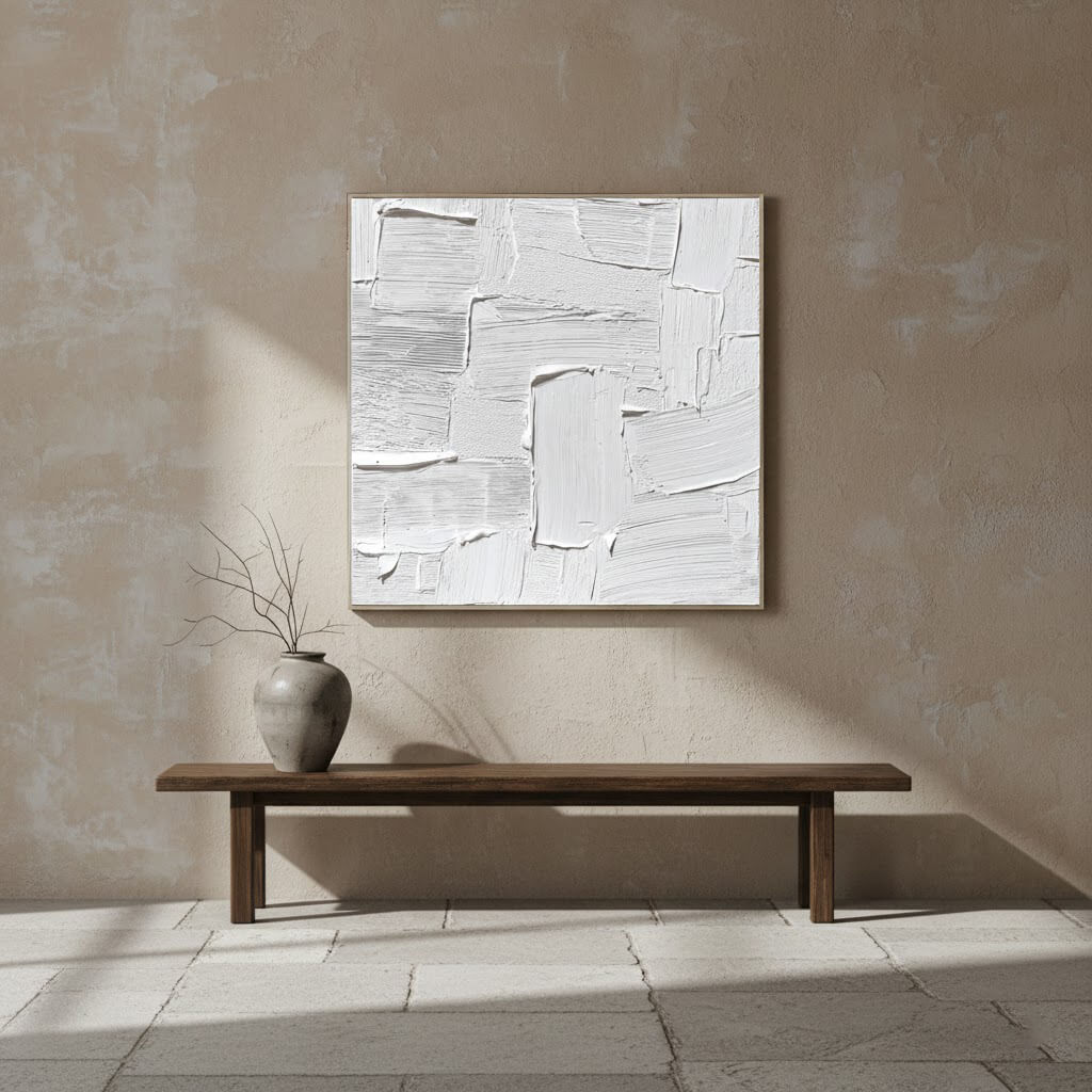 Abstract painting on a wall above a wooden bench with a vase.