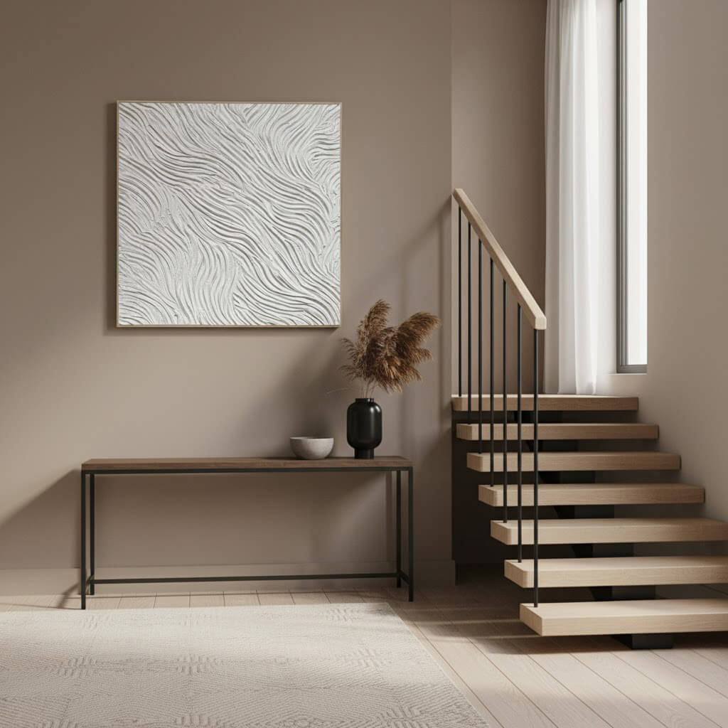 Modern interior with a console table, abstract painting, and staircase.