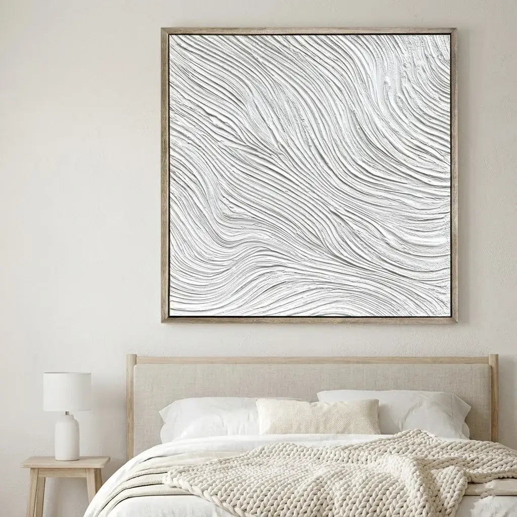 Framed abstract art above a bed in a bedroom setting