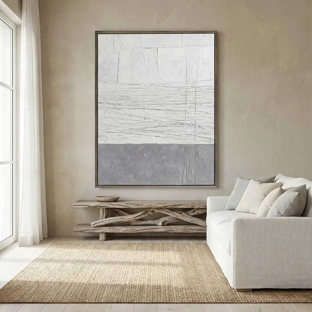 Modern living room with abstract art, white sofa, and natural elements.