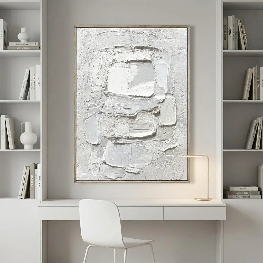 Abstract art piece on a wall above a desk in a modern office setting.