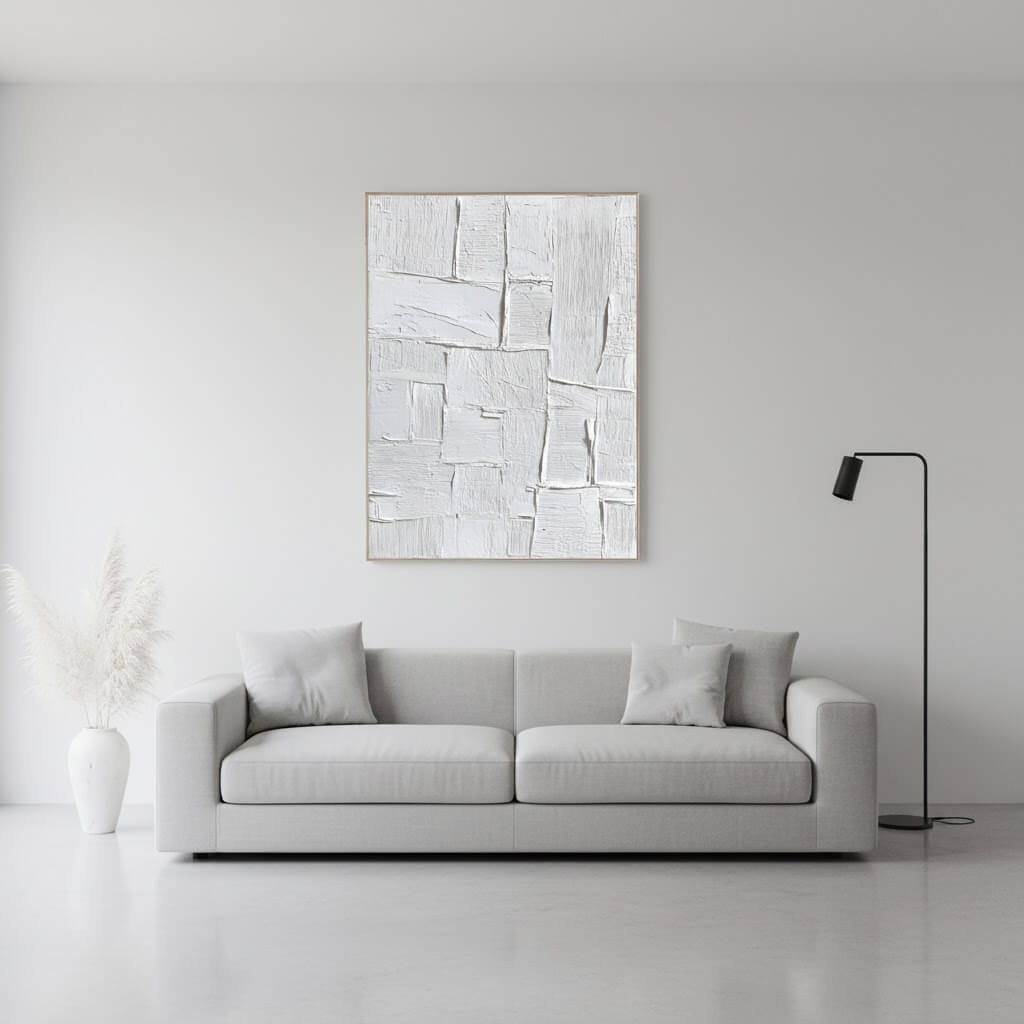 Modern living room with a gray sofa, abstract painting, and floor lamp.