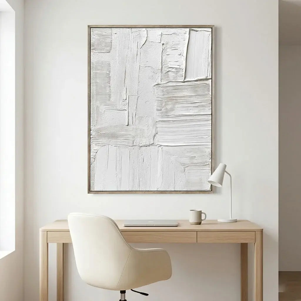 Minimalist office setup with a desk, chair, and abstract art on the wall.
