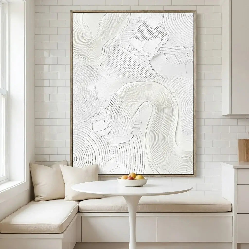 Modern interior with a large abstract painting on a wall above a white table with fruit.