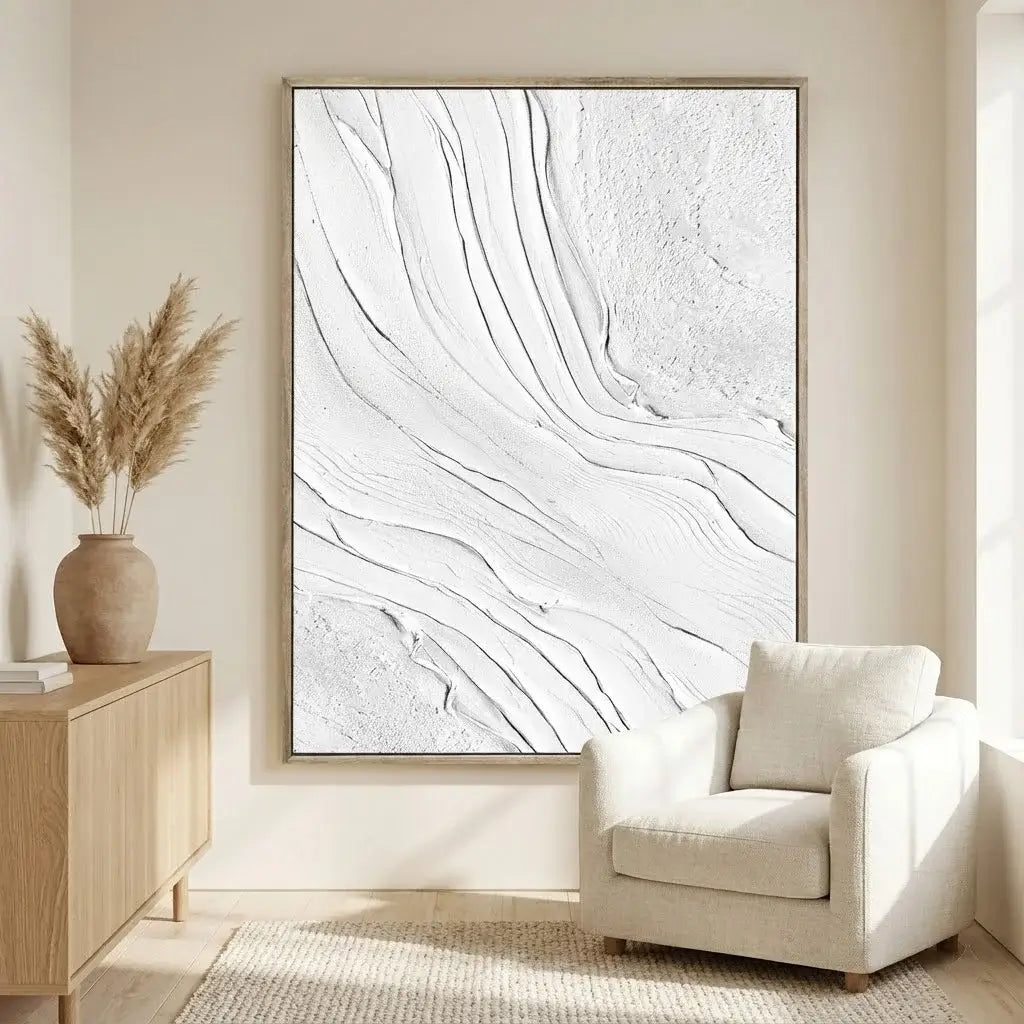 Modern living room with abstract wall art, beige armchair, and wooden side table.