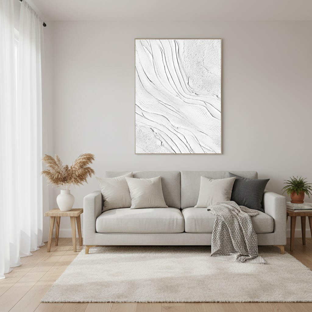 Living room with a gray sofa, abstract wall art, and decorative elements.
