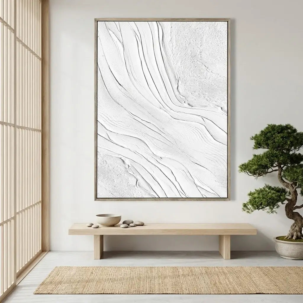 Abstract artwork in a modern interior setting with a bench and bonsai tree.