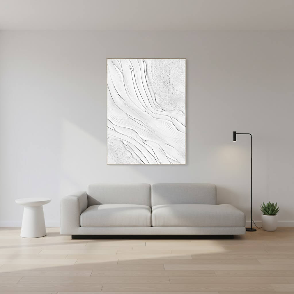 Modern living room with a gray sofa and abstract wall art.