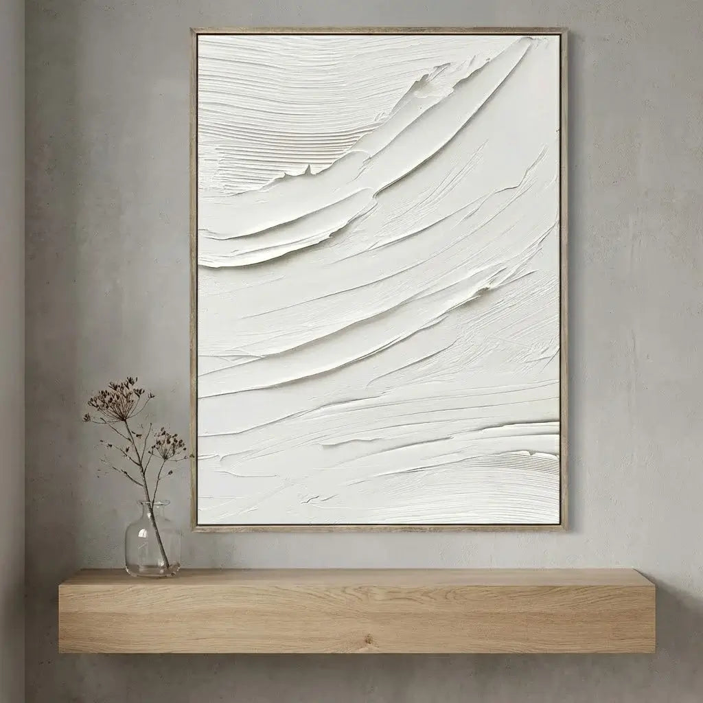Abstract art piece on a wall above a wooden console table.