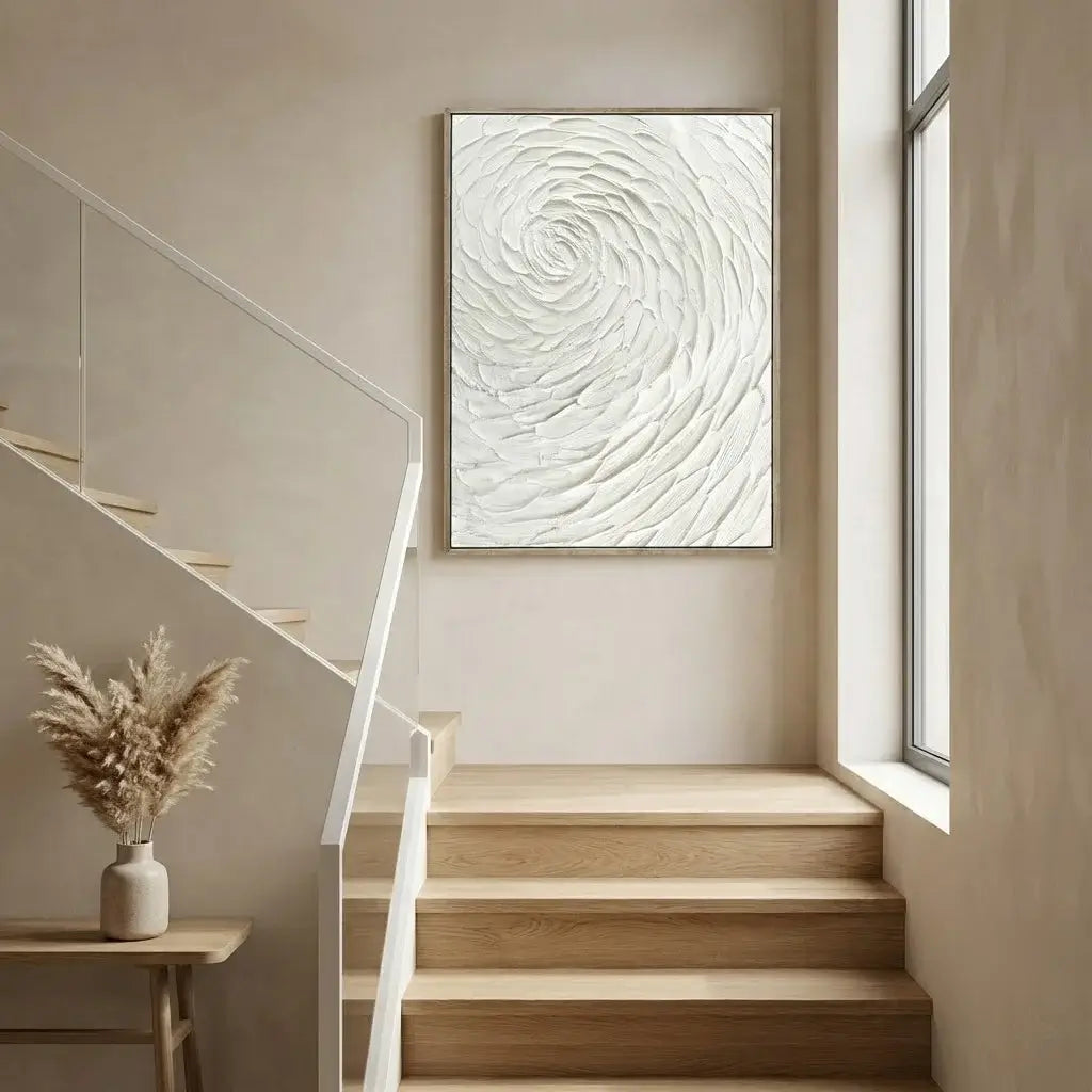 Staircase with a white abstract painting on the wall, a small table with a vase, and a window.