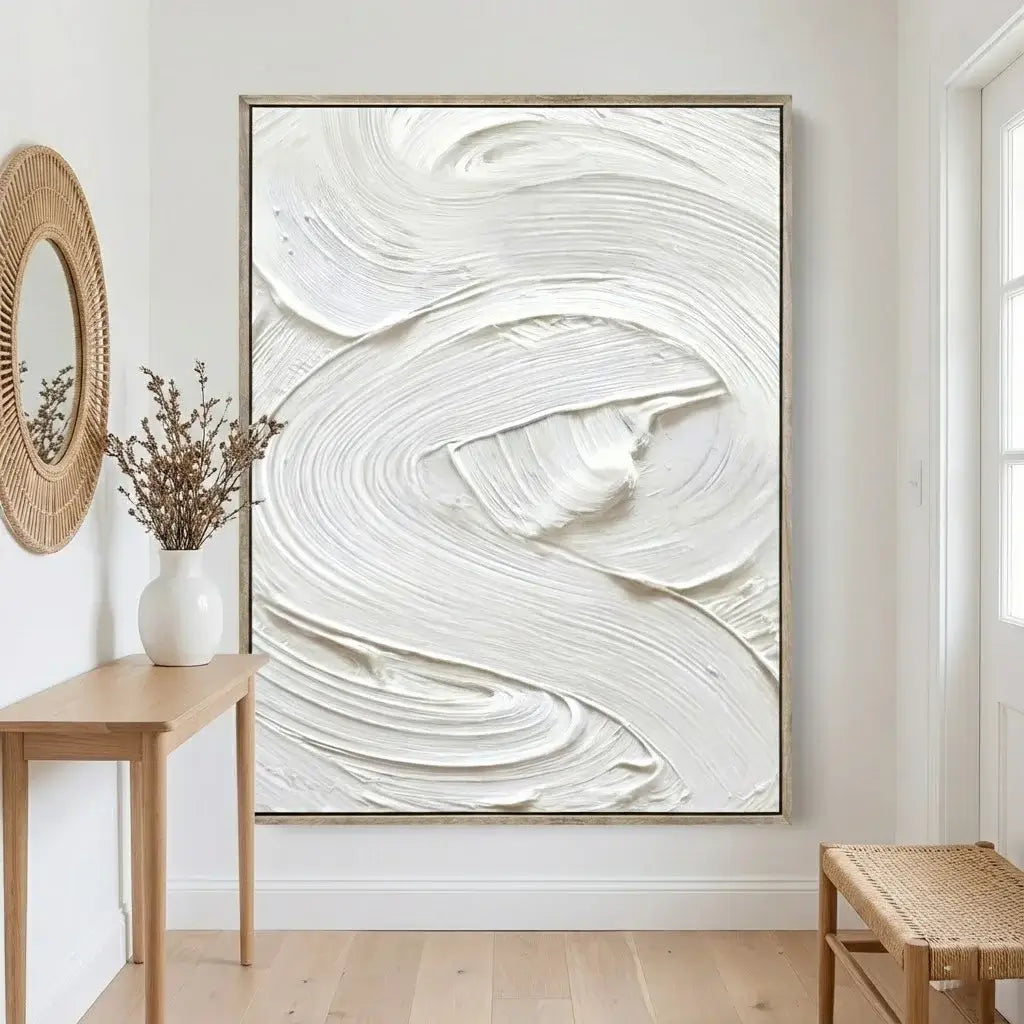 Abstract white painting on a wall in a room with wooden furniture and decor.