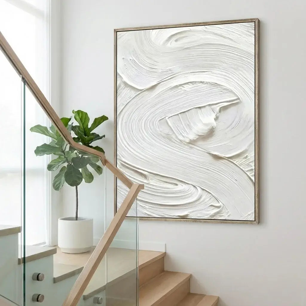 Abstract painting on a wall above a staircase with a plant to the left.