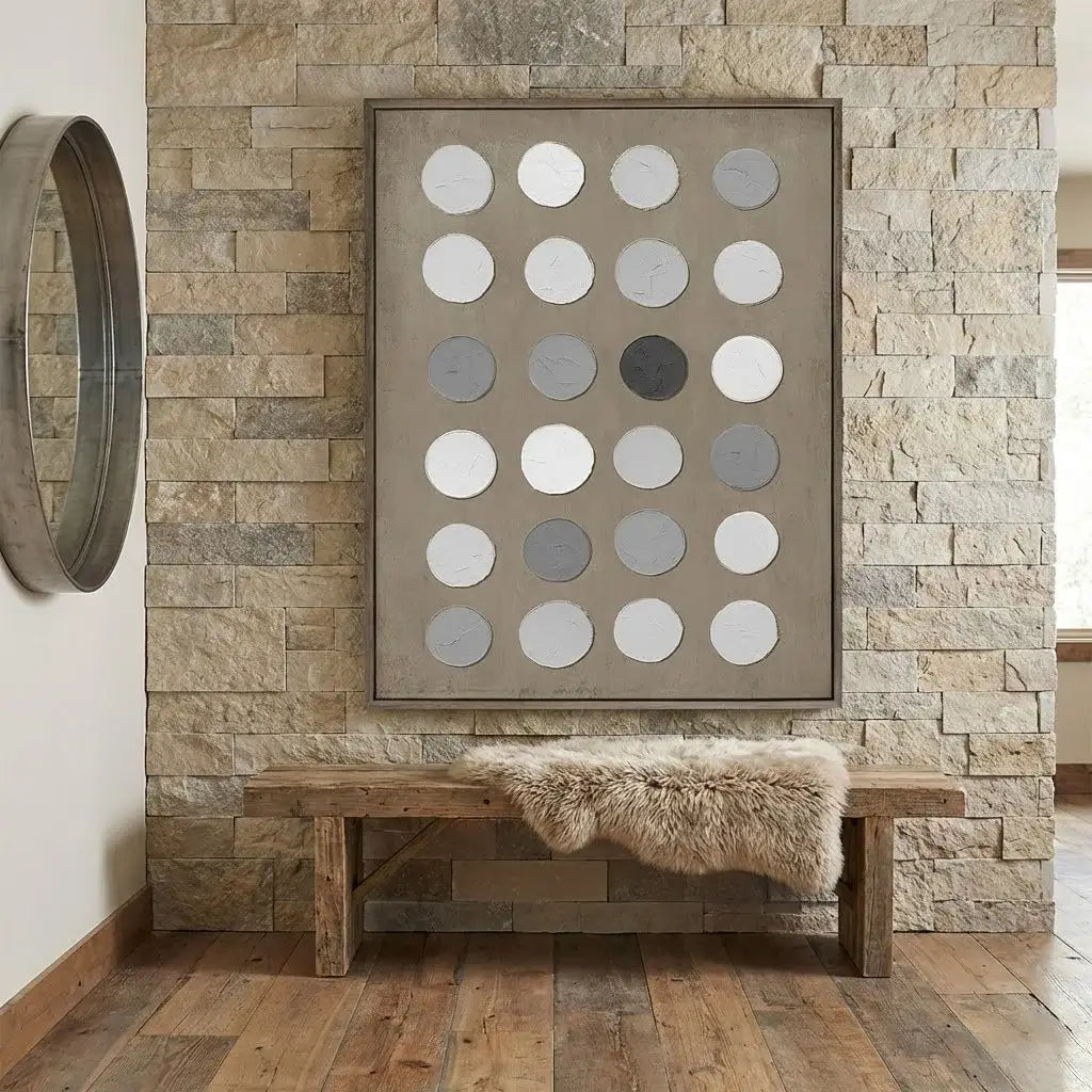 Foyer with stone wall, wooden bench, and abstract art