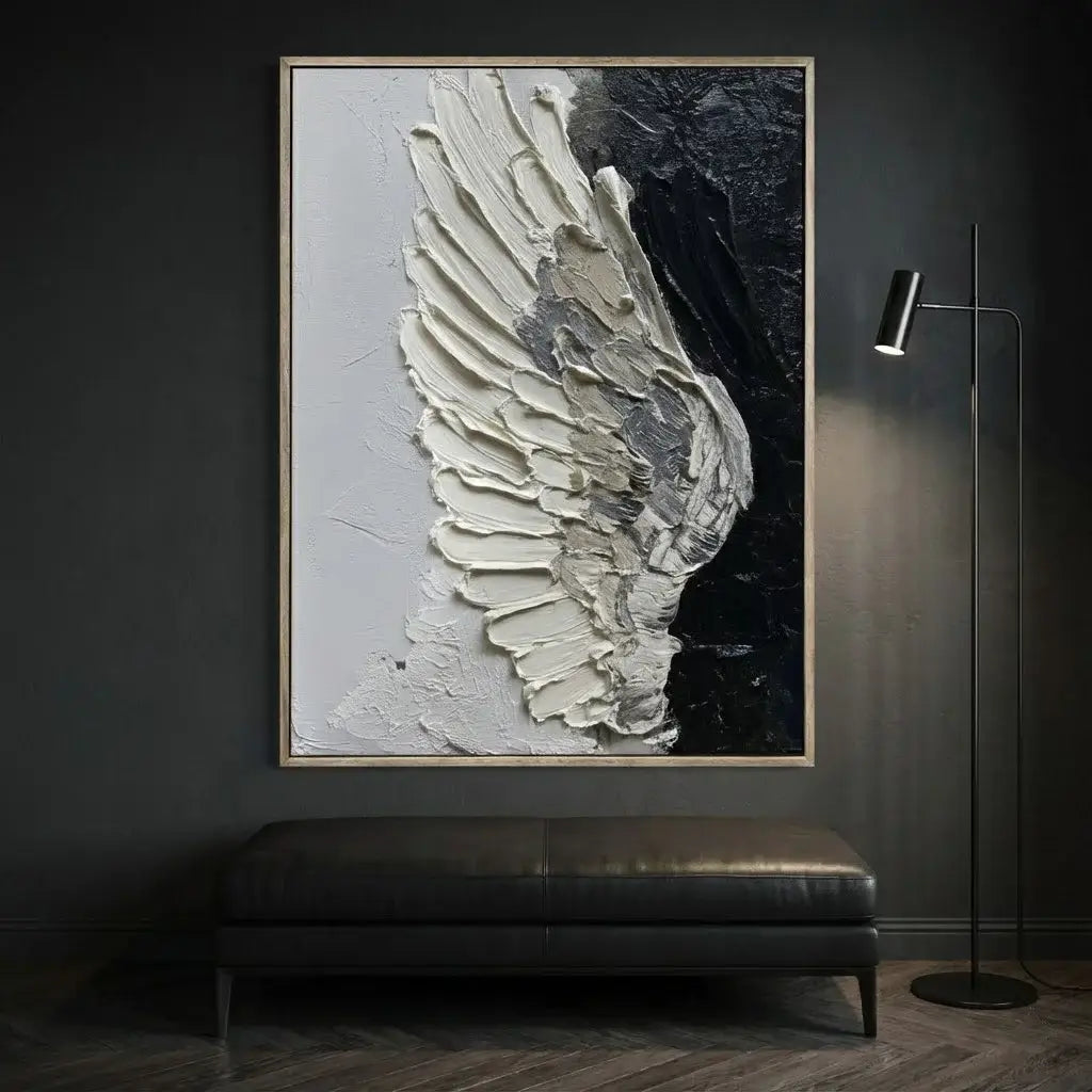 Framed abstract art of a wing on a dark wall above a bench.