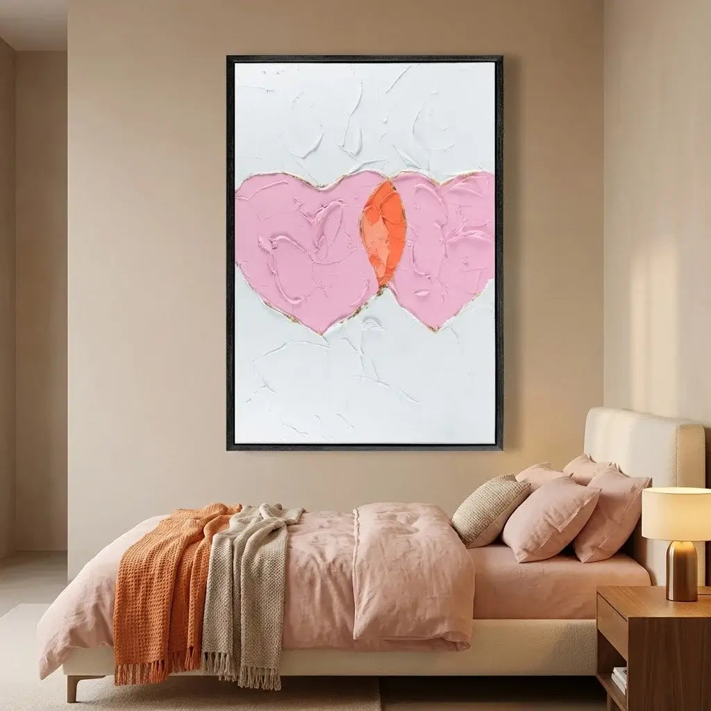 Bedroom with abstract art on the wall and a bed with pink bedding.