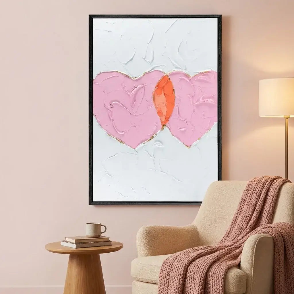 Living room with a beige armchair, wooden side table, and abstract heart artwork on the wall.