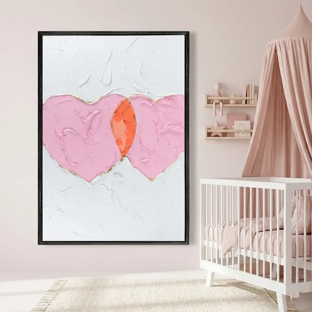 Heart-shaped abstract art in a nursery with a crib and pink canopy.