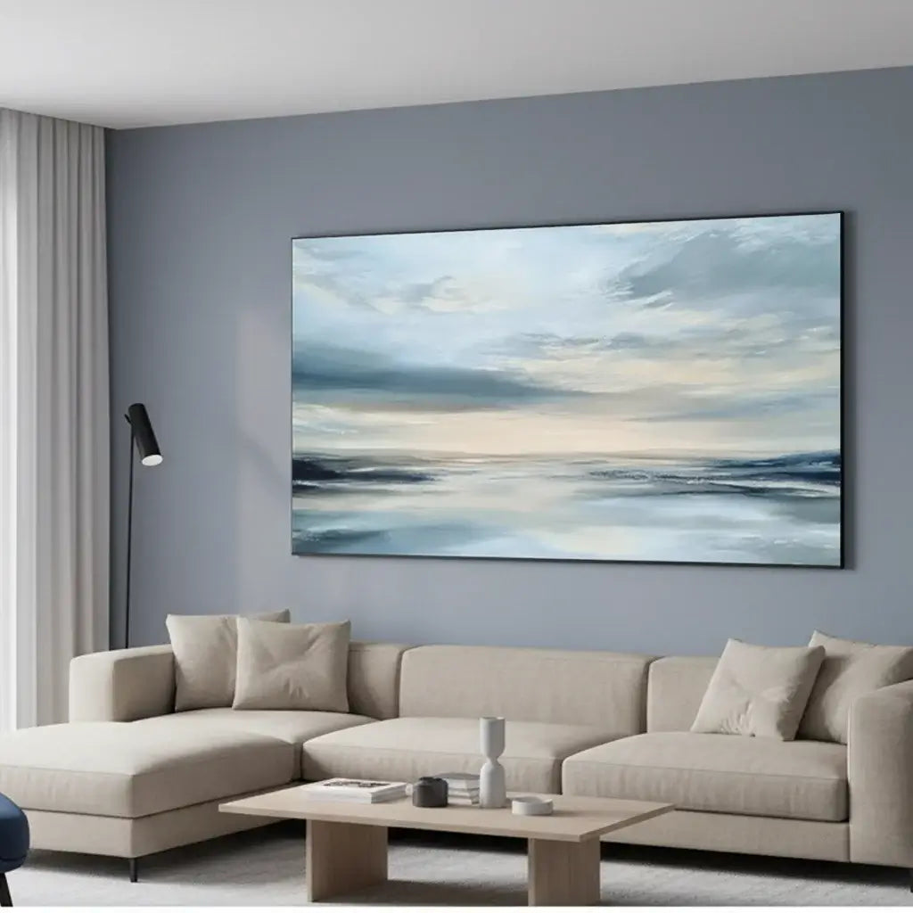 Beige sectional sofa in a living room with a large abstract painting on the wall.