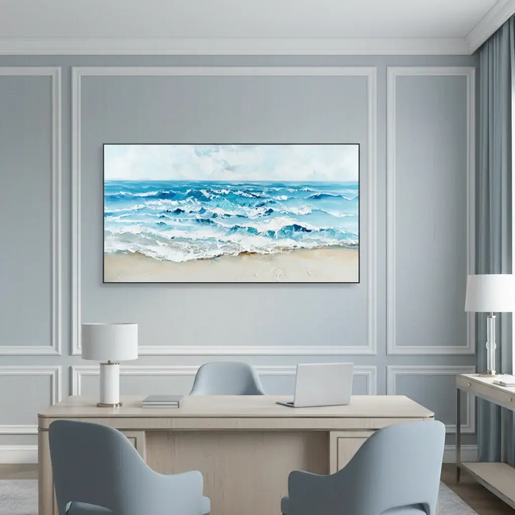 Modern office interior with a large framed beach scene on the wall.