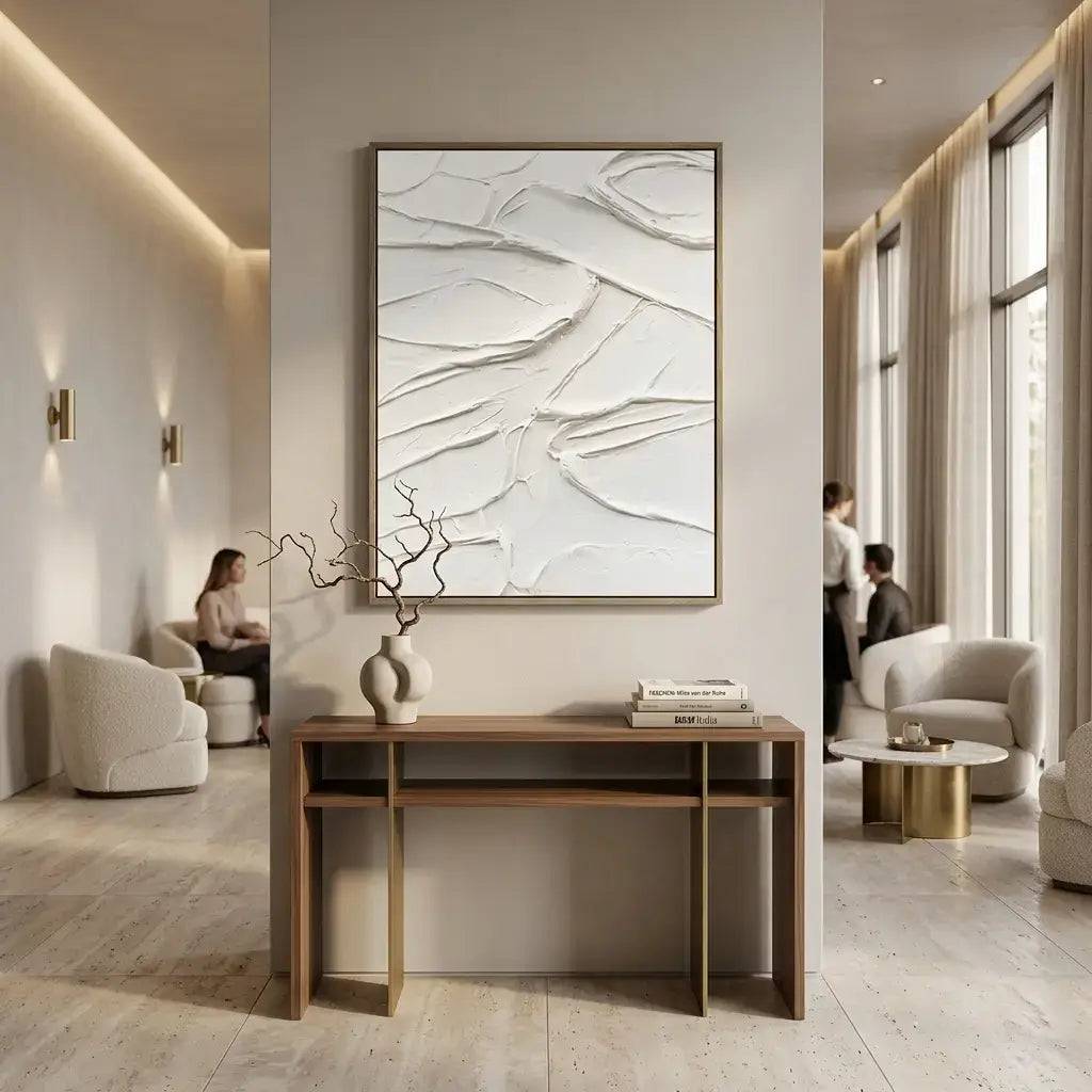 Modern living room with a wooden console table, abstract art, and comfortable seating.