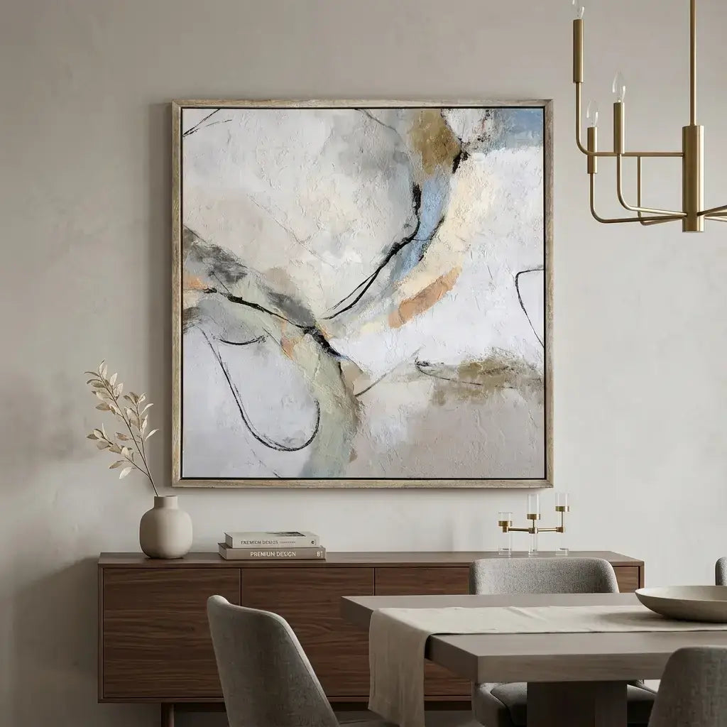 Abstract painting in a modern dining room with a wooden sideboard and chandelier.