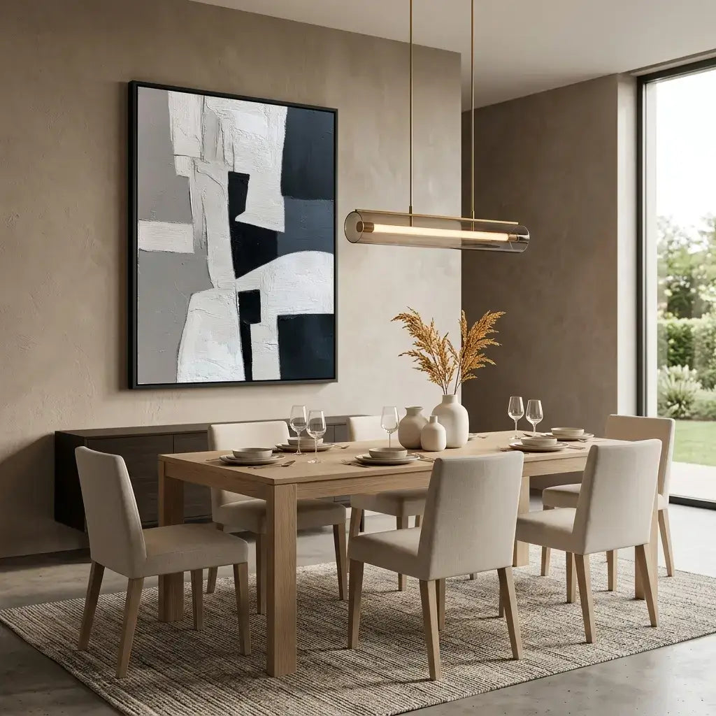 Modern dining room with wooden table and chairs, abstract art on the wall, and pendant light.