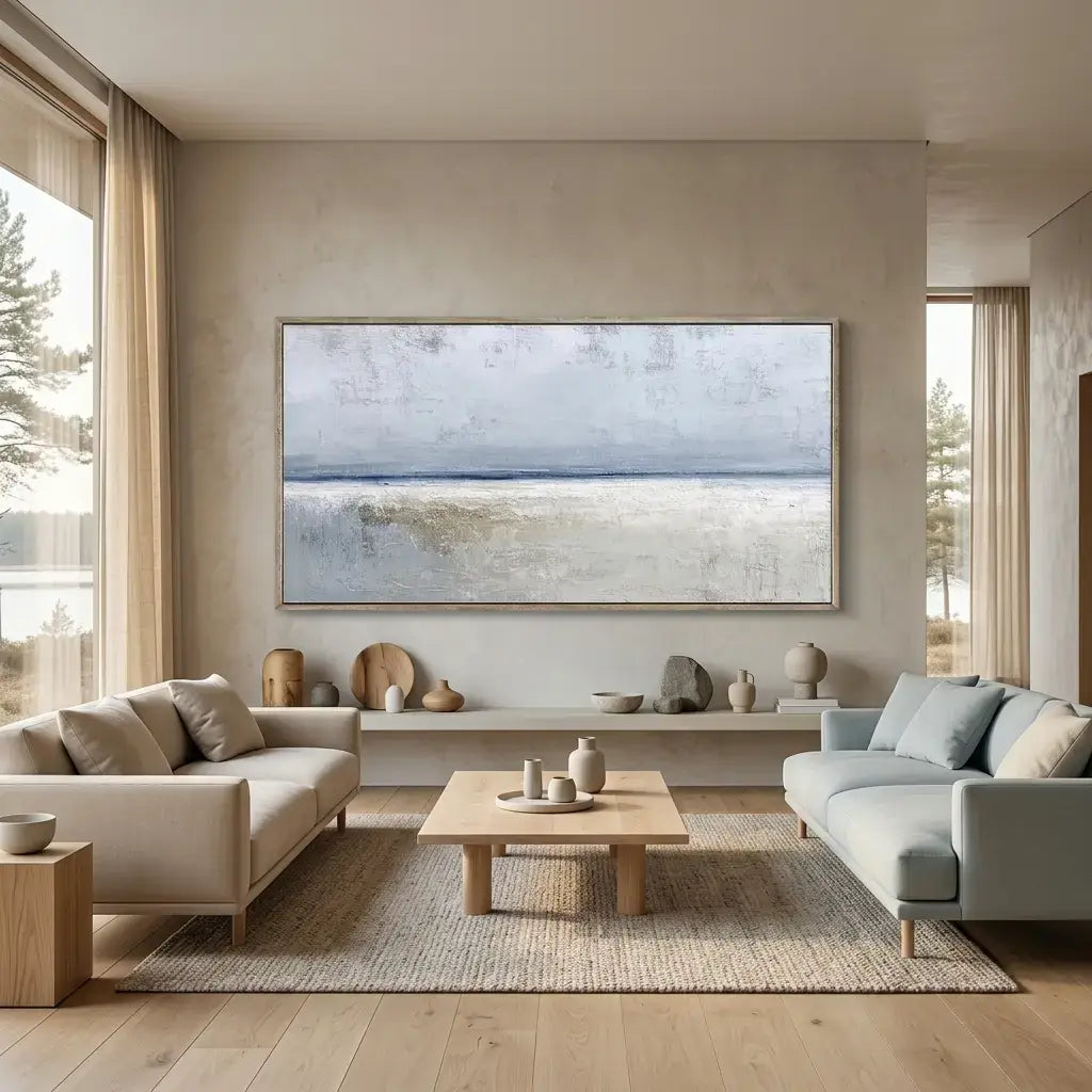 Modern living room with a neutral color scheme, large framed artwork on the wall, and a wooden coffee table.
