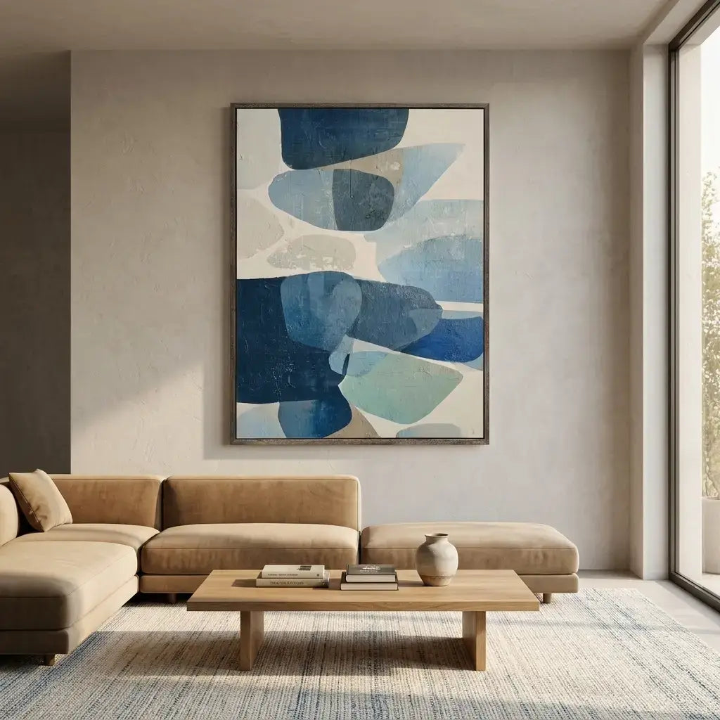 Modern living room with a beige sectional sofa, wooden coffee table, and abstract blue artwork on the wall.