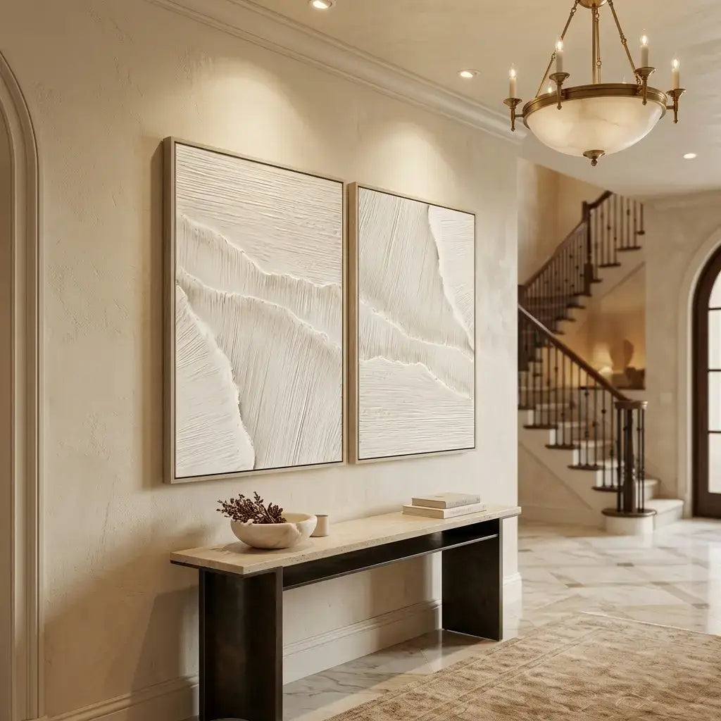 Stylish interior design with two framed artworks on a wall, a console table, and a staircase.